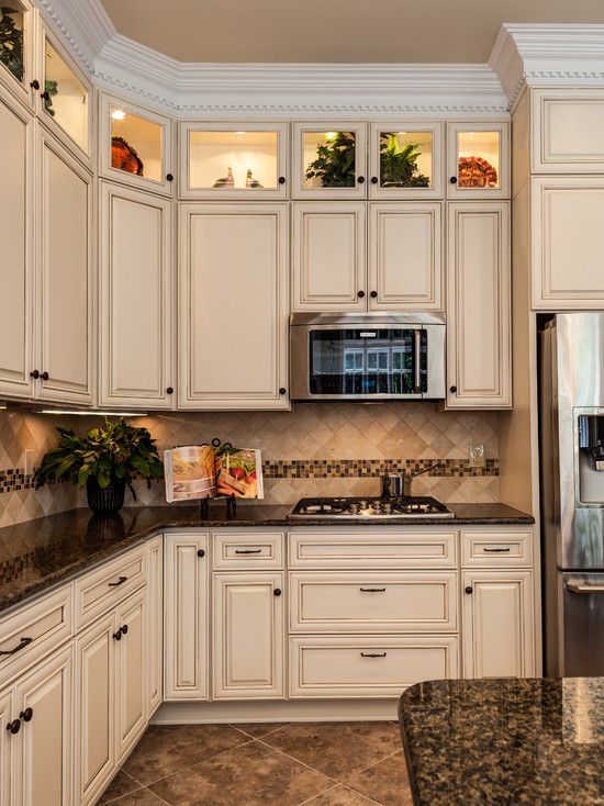 beige kitchen cabinets with dark countertops        <h3 class=
